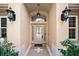 Elegant front door entryway with lanterns at 5008 Greenbriar Trl, Mount Dora, FL 32757