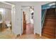 Hallway reveals a bathroom, office and stairway, connecting different areas of the home at 5008 Greenbriar Trl, Mount Dora, FL 32757