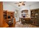 Functional home office featuring custom built-in wooden desks and shelving with natural light at 5008 Greenbriar Trl, Mount Dora, FL 32757