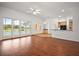 Expansive living room featuring hard wood floors, with multiple ceiling fans and glass doors to the backyard pool at 5008 Greenbriar Trl, Mount Dora, FL 32757