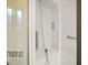 A standing shower with tile surround, shower head and grab bar at 5008 Greenbriar Trl, Mount Dora, FL 32757