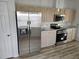 Stainless steel appliances and light wood cabinets feature in this kitchen at 9215 Sw 90Th St, Ocala, FL 34481