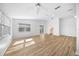 Bright living room featuring light wood flooring and a view into the kitchen at 9215 Sw 90Th St, Ocala, FL 34481