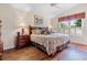 Relaxing bedroom features a comfortable bed, matching nightstands, and a window with shutters for natural light at 4830 Summerbridge Cir, Leesburg, FL 34748