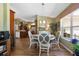 Cozy dining area features a round table with seating for four, wood floors, and view of the kitchen and living spaces at 4830 Summerbridge Cir, Leesburg, FL 34748