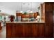 Kitchen with dark wood cabinetry, granite countertops, a center island, and pendant lighting at 4830 Summerbridge Cir, Leesburg, FL 34748