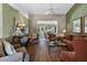 Inviting living room featuring hardwood floors, ample seating, a ceiling fan, and an arched doorway to another room at 4830 Summerbridge Cir, Leesburg, FL 34748