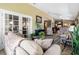 Inviting living room showcasing comfortable seating, neutral tones, tile floors, and access to outdoor spaces at 4830 Summerbridge Cir, Leesburg, FL 34748