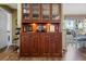 Built-in wet bar with glass-front cabinets, wine rack, and ample storage at 4830 Summerbridge Cir, Leesburg, FL 34748