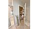 Bathroom shows a walk-in shower and an organized shelved closet at 1771 Henin Cir, Tavares, FL 32778