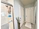 Bathroom area showcases a walk-in tiled shower, white trim, and soft gray walls at 1771 Henin Cir, Tavares, FL 32778