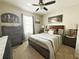 Bedroom with ceiling fan, plaid comforter, and dark wood furniture at 1771 Henin Cir, Tavares, FL 32778