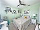 Cozy bedroom with a floral comforter, decorative pillows, and matching nightstands at 1771 Henin Cir, Tavares, FL 32778