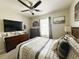 Bedroom with ceiling fan, plaid comforter, and rustic wood decor at 1771 Henin Cir, Tavares, FL 32778