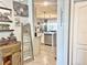 Inviting entryway view with vintage truck decor leading into a kitchen with stainless steel appliances at 1771 Henin Cir, Tavares, FL 32778