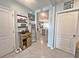 Hallway view featuring farmhouse decor with an opening looking into the kitchen and tile flooring at 1771 Henin Cir, Tavares, FL 32778