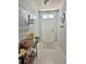 Welcoming foyer features a decorated console table, tiled floor, and charming decor at 1771 Henin Cir, Tavares, FL 32778