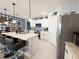 Bright kitchen with a breakfast bar, modern appliances, and custom backsplash, creating a stylish and functional cooking space at 1771 Henin Cir, Tavares, FL 32778