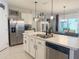 Modern kitchen boasts stainless steel appliances, sleek countertops, and ample cabinet space for culinary enthusiasts at 1771 Henin Cir, Tavares, FL 32778