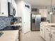 Efficient kitchen layout with modern appliances, ample counter space, and sleek cabinetry, creating a functional and stylish cooking area at 1771 Henin Cir, Tavares, FL 32778