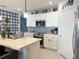 Well-appointed kitchen featuring a center island, stainless steel appliances, and custom cabinetry, perfect for cooking and gathering at 1771 Henin Cir, Tavares, FL 32778