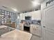 Bright kitchen with white cabinets, center island, and stainless steel appliances at 1771 Henin Cir, Tavares, FL 32778