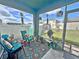 Cozy screened-in lanai with colorful decor, patio furniture, and a view of the backyard at 1771 Henin Cir, Tavares, FL 32778