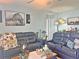 Comfortable living room featuring cozy seating, stylish decor, and natural light, perfect for relaxing or entertaining guests at 1771 Henin Cir, Tavares, FL 32778