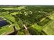 Beautiful aerial view of a lush and expansive property with mature trees, ponds, and a private bridge at 26012 Splendid Meadow Ct, Astatula, FL 34705