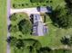 Aerial view of house with a pool and a long driveway in a wooded area at 26012 Splendid Meadow Ct, Astatula, FL 34705
