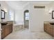 Large bathroom featuring tile floors, granite countertops, double sinks and a walk-in shower at 26012 Splendid Meadow Ct, Astatula, FL 34705
