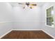 Bright bedroom featuring hardwood floors, base molding and a ceiling fan with lots of natural light at 26012 Splendid Meadow Ct, Astatula, FL 34705