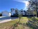 House exterior showcasing landscaping and detached garage at 26012 Splendid Meadow Ct, Astatula, FL 34705