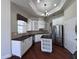 Well-lit kitchen with stainless steel appliances, white cabinetry and sleek dark countertops and backsplash at 26012 Splendid Meadow Ct, Astatula, FL 34705