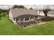 A screened pool with a view of the lawn at 26012 Splendid Meadow Ct, Astatula, FL 34705