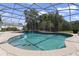 Sparkling in-ground pool surrounded by a screened enclosure, mature trees and lots of privacy at 26012 Splendid Meadow Ct, Astatula, FL 34705