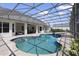 Beautiful in-ground pool surrounded by a screened enclosure, outdoor seating and a well-manicured backyard at 26012 Splendid Meadow Ct, Astatula, FL 34705