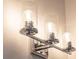 Modern three-light vanity fixture with glass shades at 10643 Grand Oaks Blvd, Oxford, FL 34484