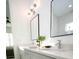 Bathroom vanity with quartz countertops, black framed mirrors, and modern lighting at 10643 Grand Oaks Blvd, Oxford, FL 34484