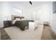 Bright bedroom with a neutral color scheme, a ceiling fan, and a white accent bench at 10643 Grand Oaks Blvd, Oxford, FL 34484