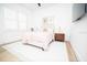 Cozy bedroom with neutral decor, a white rug, and a window with blinds at 10643 Grand Oaks Blvd, Oxford, FL 34484