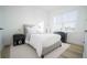 Bright bedroom with neutral decor, a white rug, and a modern night stand at 10643 Grand Oaks Blvd, Oxford, FL 34484