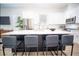 Kitchen island with seating offers a great space for dining and entertaining in this modern home at 10643 Grand Oaks Blvd, Oxford, FL 34484