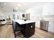 Modern kitchen island with seating, a stainless steel dishwasher, and lots of storage at 10643 Grand Oaks Blvd, Oxford, FL 34484