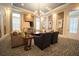 Cozy living room with comfortable seating, wood accent wall, and ample natural light at 10643 Grand Oaks Blvd, Oxford, FL 34484