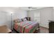 Bedroom with ceiling fan, window shutters, and colorful bedding at 2968 Wotring Way, The Villages, FL 32163