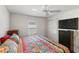 Spacious bedroom with a large TV, ceiling fan, and double-door closet at 2968 Wotring Way, The Villages, FL 32163