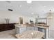 Island kitchen with granite countertops, breakfast bar, and view to Gathering room at 2968 Wotring Way, The Villages, FL 32163