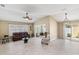 Open living room with vaulted ceilings and a cozy sitting area at 2968 Wotring Way, The Villages, FL 32163