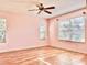 Light pink bedroom with hardwood floors and ceiling fan at 9400 Se 176Th Saffold St, The Villages, FL 32162